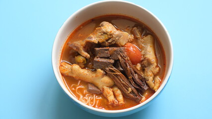 rice vermicelli with northern thai curry sauce on blue background