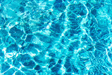 Ripples on the surface of the water in a blue swimming pool
