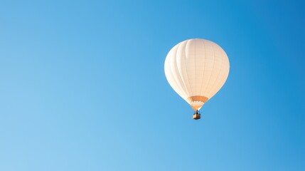 Obraz premium White hot air balloon soaring, clear blue sky, travel, adventure