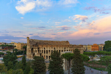 Fototapeta premium The great Roman Colosseum also known as the Flavian Amphitheater on a sunny day with deep blue sky, beautiful clouds and no people visible 