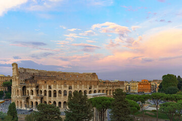 Obraz premium The great Roman Colosseum also known as the Flavian Amphitheater on a sunny day with deep blue sky, beautiful clouds and no people visible 