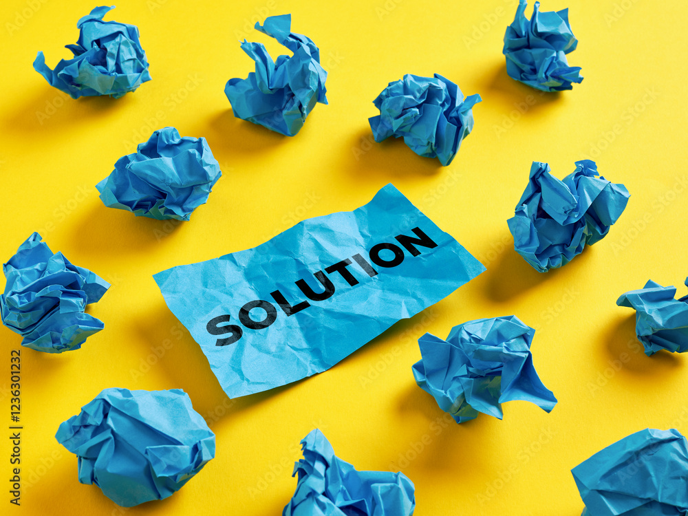 Poster to search for or find a solution for a problem. the word solution on piece of paper among the crumpl
