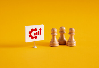 Chess pawns near a banner with growth graph chart symbol.