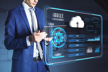 Agile development interface with businessman using tablet, holographic cloud, and system graphics.
