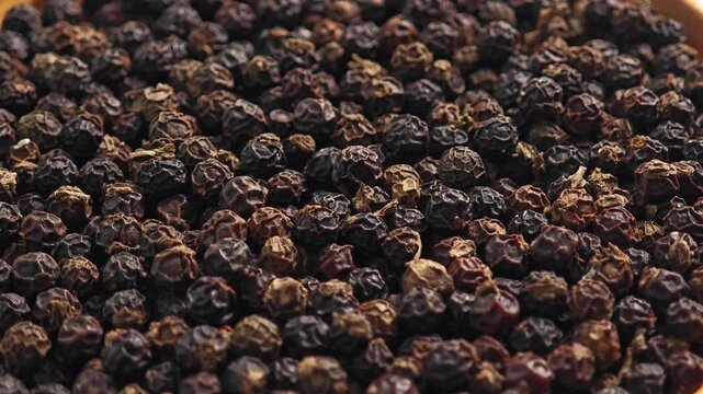 Black peppercorns on a plate wooden