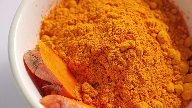 Yellow turmeric powder in a bowl