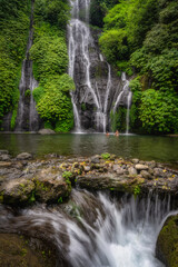 A breathtaking Banyumala Twin Waterfalls, enveloped by lush, vibrant greenery, beckons visitors to enjoy a serene, peaceful escape into the remarkable beauty of nature all around, Bali, Indonesia