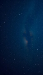 Fototapeta premium Astrophotography of a dark blue starry sky with many stars, nebulae and galaxies. Panoramic wide horizontal photo for banner head cover, low-poly. isolated with white shades