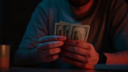 Counting cash in low light, exploring finances and money management techniques at night