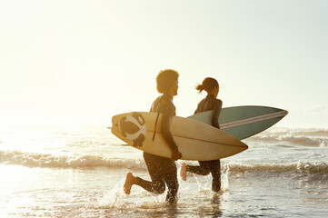 Man, woman and surfing with running by sea for fitness, waves and training together in summer sunshine. Friends, surfboard and sunset workout with happiness, free and mockup space by ocean on holiday