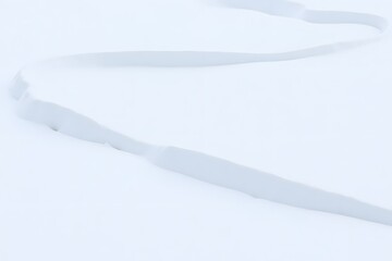 Fototapeta premium Serene winter landscape with gentle snowdrift curves in isolated setting