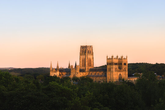 Idyllic view of Durham Cathedral during golden hour with serene surroundings and sunset hues from Wharton Park.