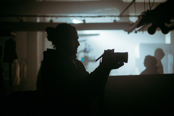 Director of photography with a camera in his hands on the set. Professional videographer at work on...