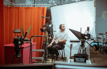 Director of photography with a camera in his hands on the set. Professional videographer at work on...