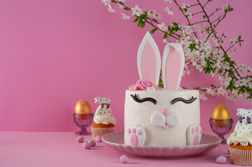 Easter bunny celebration cake on a plate on a pink background. Funny food idea. Copy space.