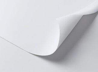 Close-up of a curled white paper corner, showing texture and shadows.