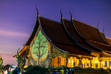 Background of the tourist attraction Wat Sirindhorn Wararam or the famous glowing temple in...