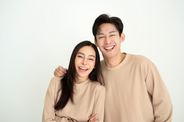 Couple Smiling Together in Matching Outfits, Showcasing a Warm and Friendly Atmosphere at Home