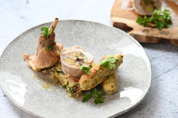 Stuffing a rabbit roulade with a flavorful spinach filling, showcasing the cooking process of this traditional Czech dish. 