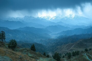 Obraz premium Majestic mountain landscape under dramatic cloudy sky at dusk in the Himalayas