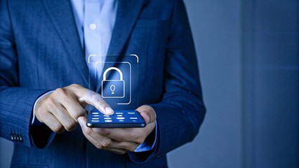 A businessman holding mobile showing Padlock icon amidst a digital overlay representing modern technology, showcasing innovation in the business world.