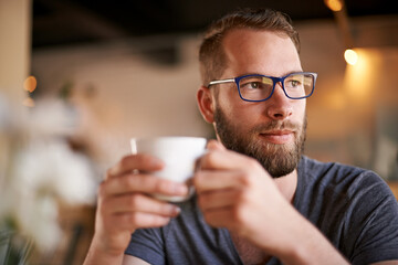 Coffee, thinking and man in restaurant with remote work for digital nomad career with travel for creativity. Ideas, cappuccino and copywriter with caffeine drink in cafe for project in morning.