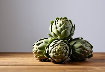 Obraz premium Fresh and raw artichokes were placed on the kitchen table