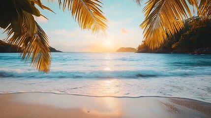 Fototapeta premium Tropical beach sunset scene with palm leaves framing the ocean.