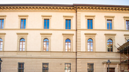 Exterior facade of Palazzo della Sapienza in Pisa, showcasing its historic architecture