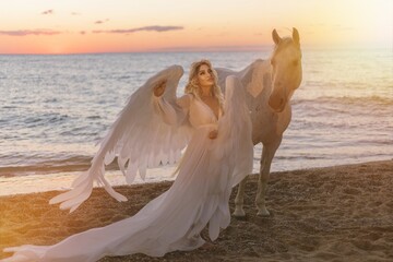 Young long-haired woman in a white dress riding a white horse against a seascape