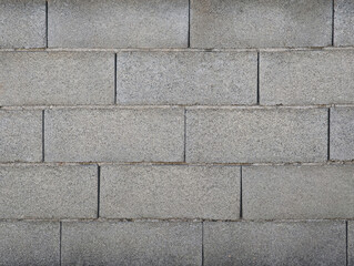 Obraz premium Grey rectangular porous concrete blocks exterior wall texture. Gray cement bricks for construction, house walls, facade, enclosure, division of plots.
