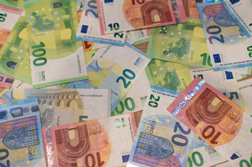 Euro banknotes scattered on table
