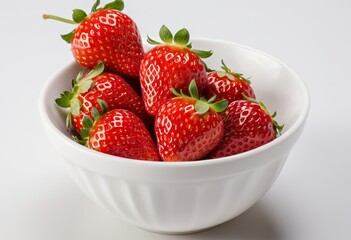 Close-up of strawberries in a bowl against a white background