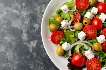 Fresh Mediterranean salad with feta cheese, tomato, olives, onion and basil leaves, Healthy food