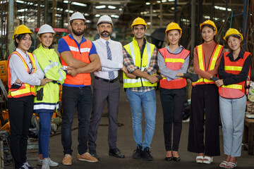 group of diversity engineer factory worker standing in row holding hand with business man manager or executive boss leader team together in industry manufacturing warehouse.