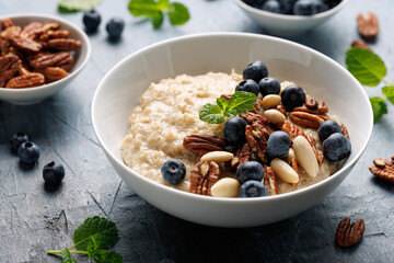 Oatmeal porridge with blueberry, almonds, and pecan healthy food breakfast.