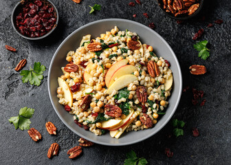Warm barley pearl salad with kale, dried cranberries, apples and roasted pecan nuts. Healthy food