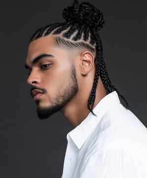 A man with box braids styled into a man bun