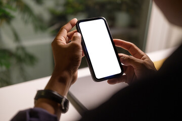 Hands holding smartphone with empty screen for showcasing mobile applications, advertisements, or digital content.