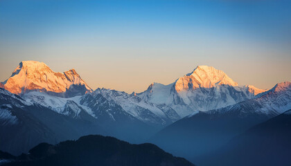 Fototapeta premium majestic snow capped mountain peaks beneath a clear sky at sunrise