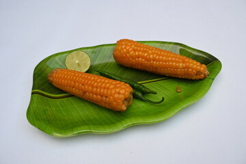 Boiled sweet corn on the plate. This is a complete food for humans. It contains many vitamins, such as Vitamin B1, B5, C, B9, E, A. Boiled corn on the cob. It's like all over world.  Heathy eating. 