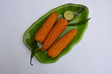 Boiled sweet corn on the plate. This is a complete food for humans. It contains many vitamins, such as Vitamin B1, B5, C, B9, E, A. Boiled corn on the cob. It's like all over world.  Heathy eating. 