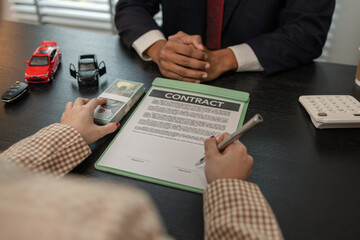 a car salesperson is explaining the details of a car purchase contract to the buyer before signing the sales contract, showroom, dealer, car contract, sining a car purchase contract