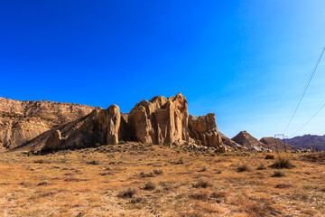 A rocky hillside with a clear blue sky