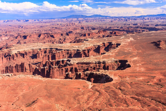 A desert landscape with a canyon in the middle