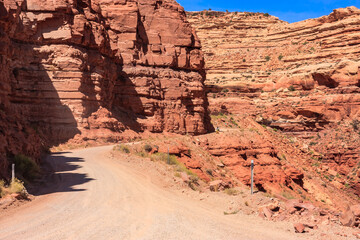 A dirt road winds through a rocky canyon