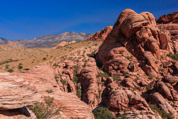 A rocky mountain range with a clear blue sky