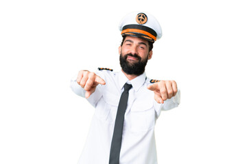 Airplane caucasian pilot man over isolated chroma key background points finger at you while smiling