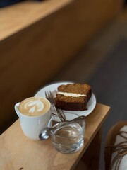 White coffee with latte art in a white cup on a wooden  table. Coffee with milk