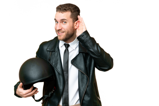 Business man with a motorcycle helmet over isolated chroma key background listening to something by putting hand on the ear